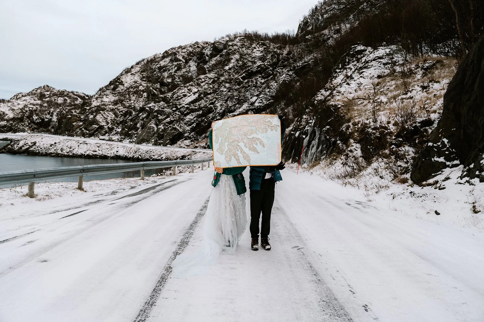 couple during Norway elopement standing on the road in the snow