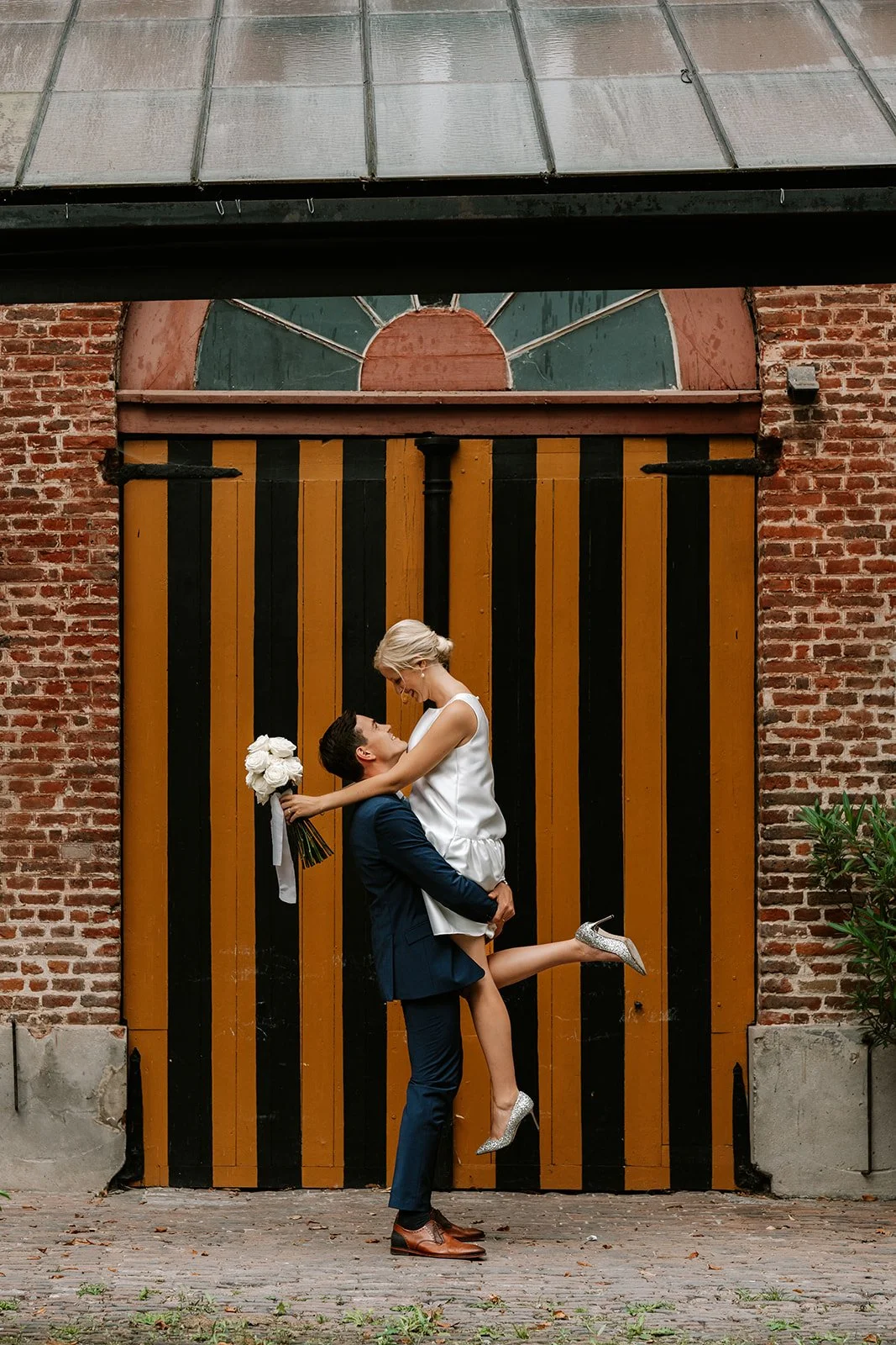 groom lifting the bride during relaxed photoshoot