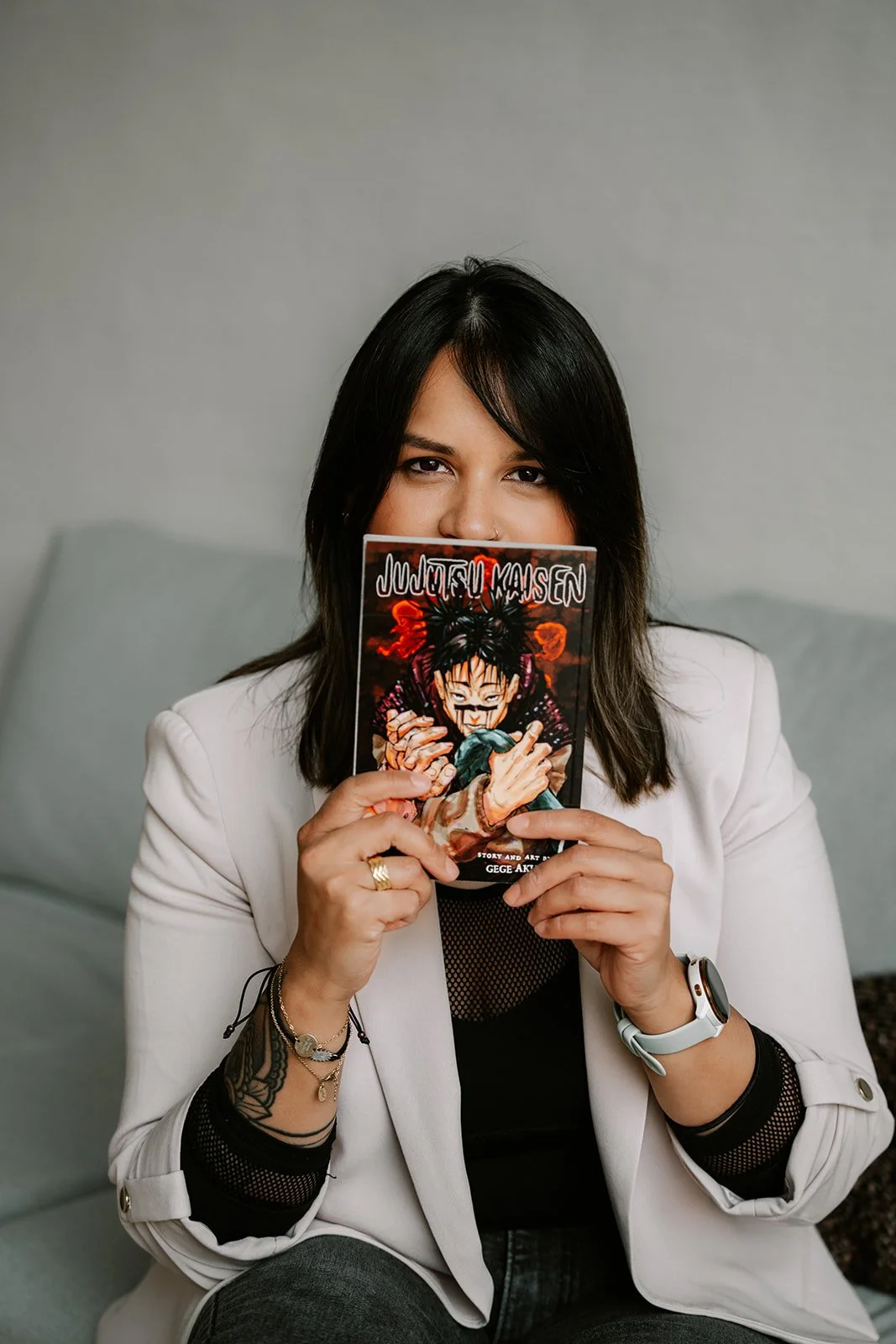 branding photoshoot of a woman holding up a manga 