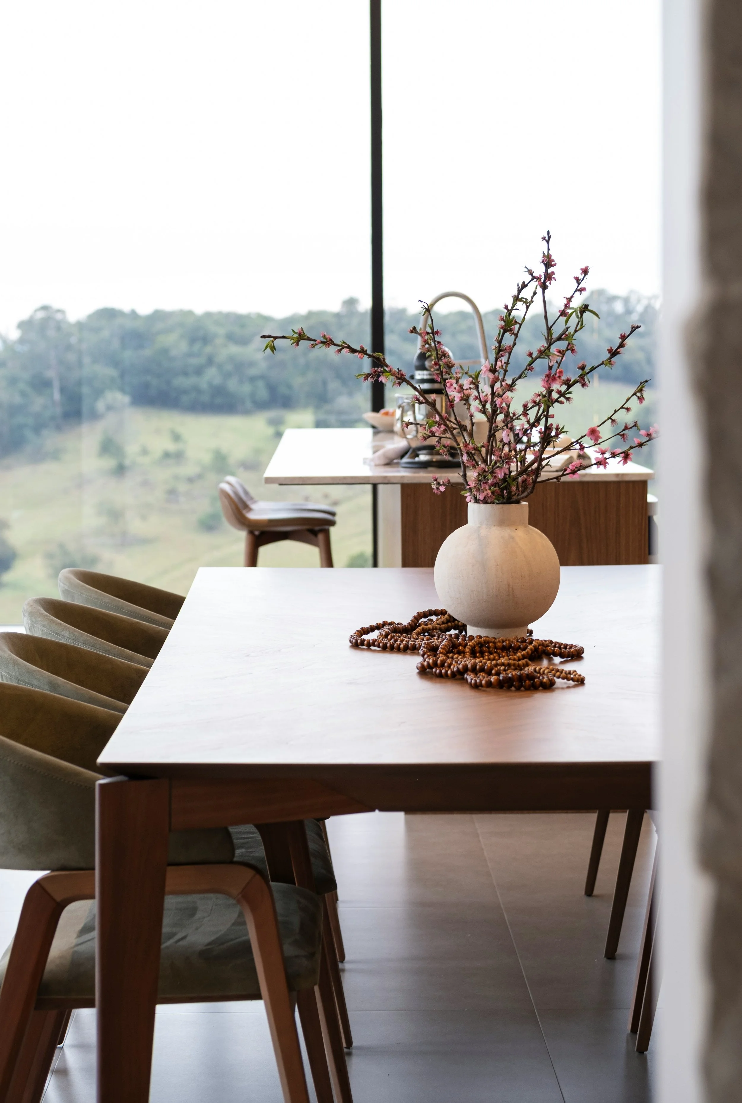 Espacio de comedor luminoso con tonos cálidos y diseño sereno en vivienda contemporánea