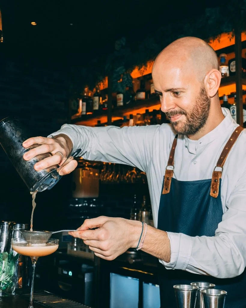 A bartender at Burger & Lobster pouring a cocktail for Brighton Cocktail Festival.