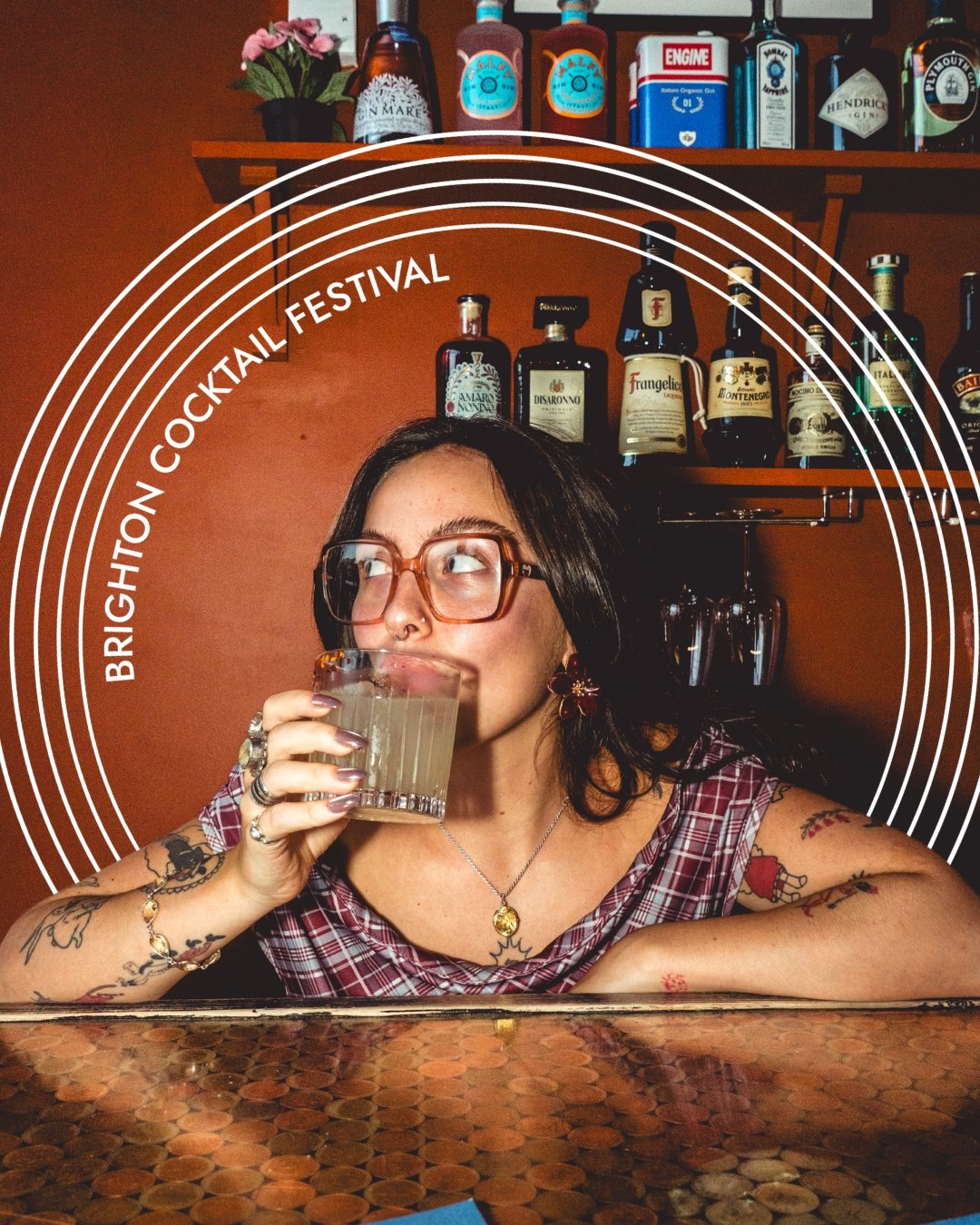 A bartender drinking a cocktail with the words Brighton Cocktail Festival in a circle around her.