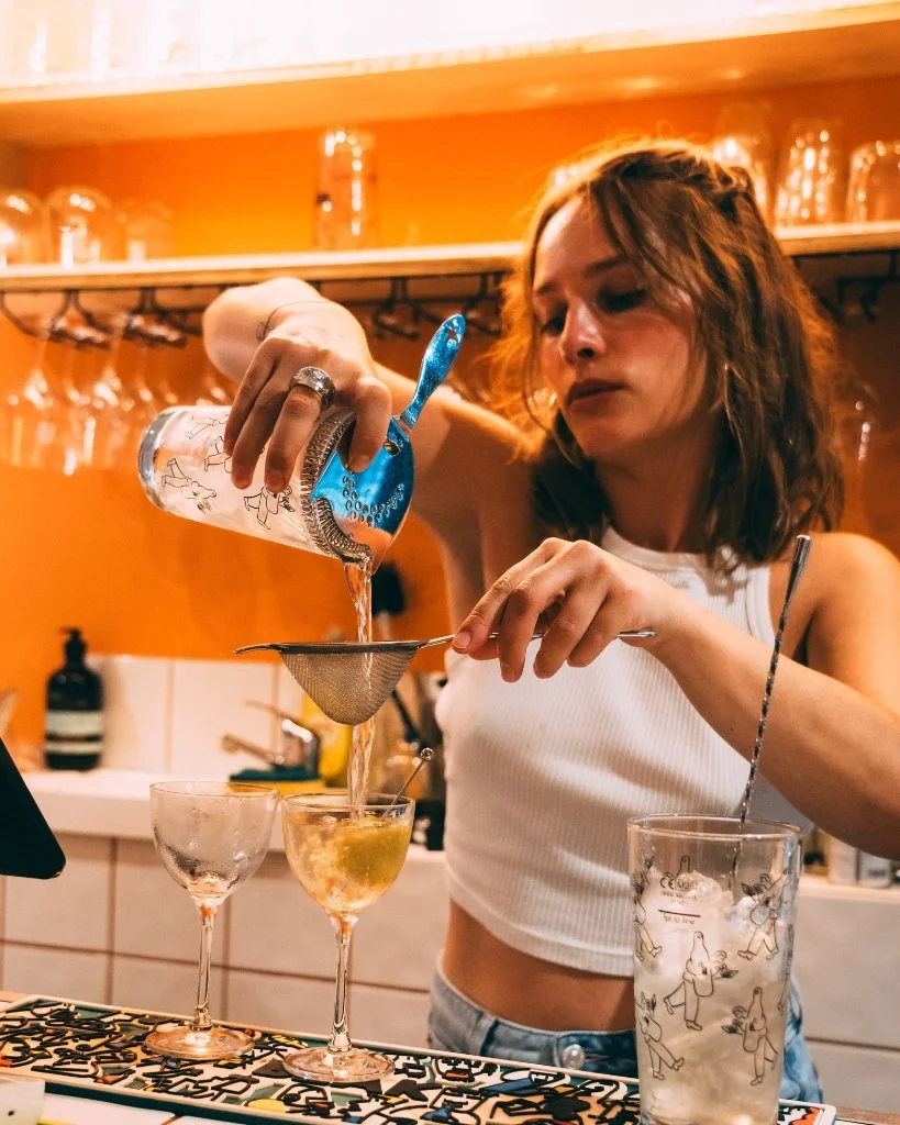 A bartender at Vine Street Tap pouring a cocktail for Brighton Cocktail Festival.