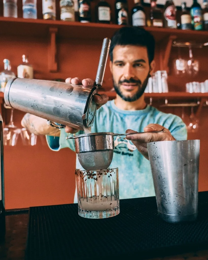 A bartender at Bar 50ml pouring a cocktail for Brighton Cocktail Festival.