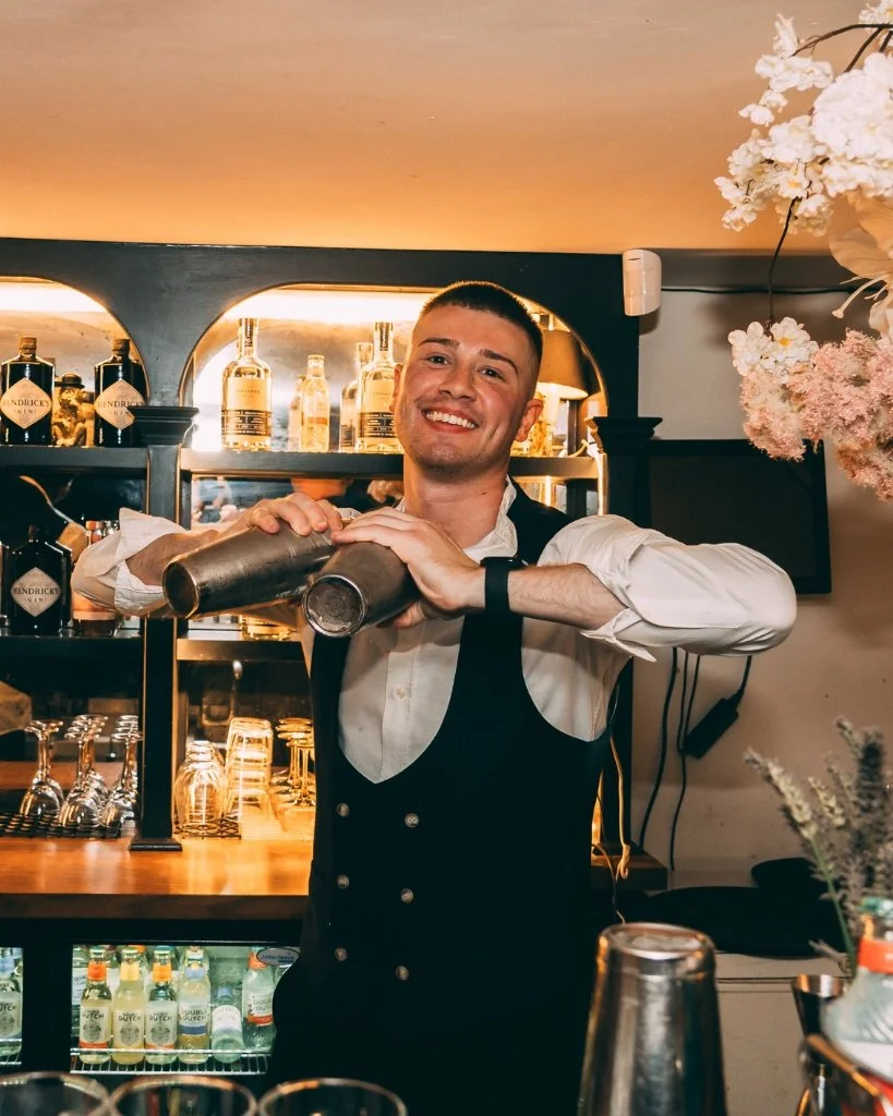 A bartender at Bar Medusa shaking a cocktail for Brighton Cocktail Festival