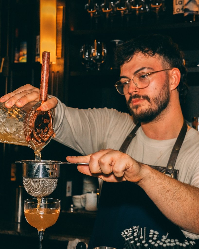 A bartender from No.124 by GuestHouse pouring a drink for Brighton Cocktail Festival.