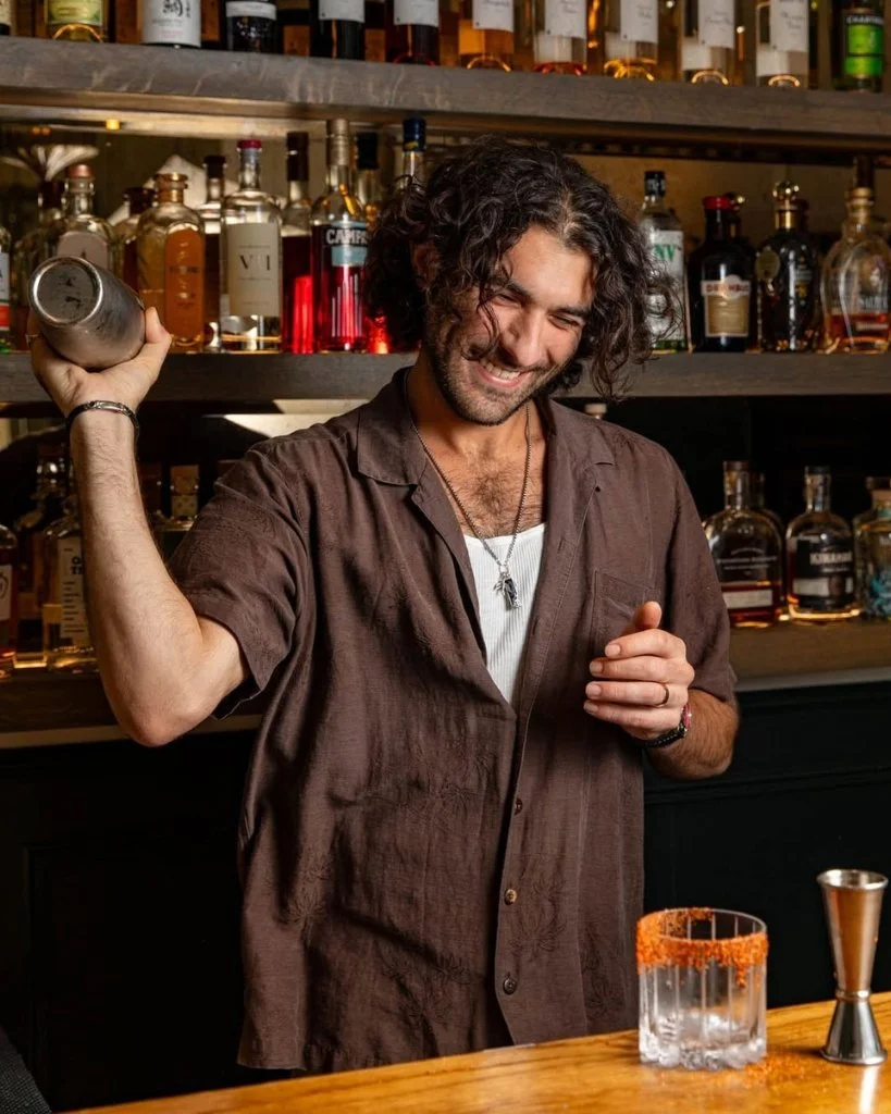A bartender shaking a cocktail at Furna