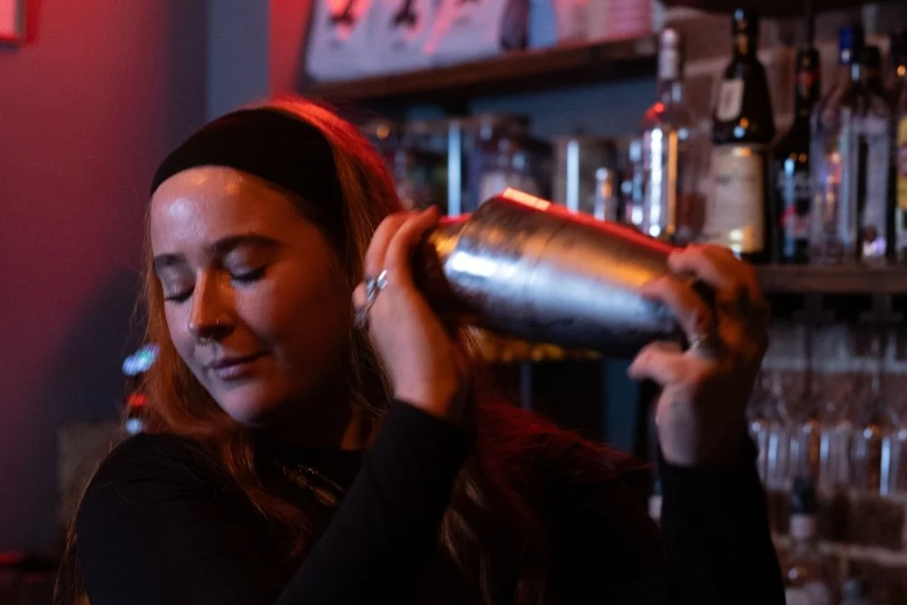 A bartender shaking a cocktail