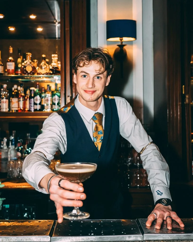 A bartender raising a Brighton Cocktail Festival cocktail at The Grand