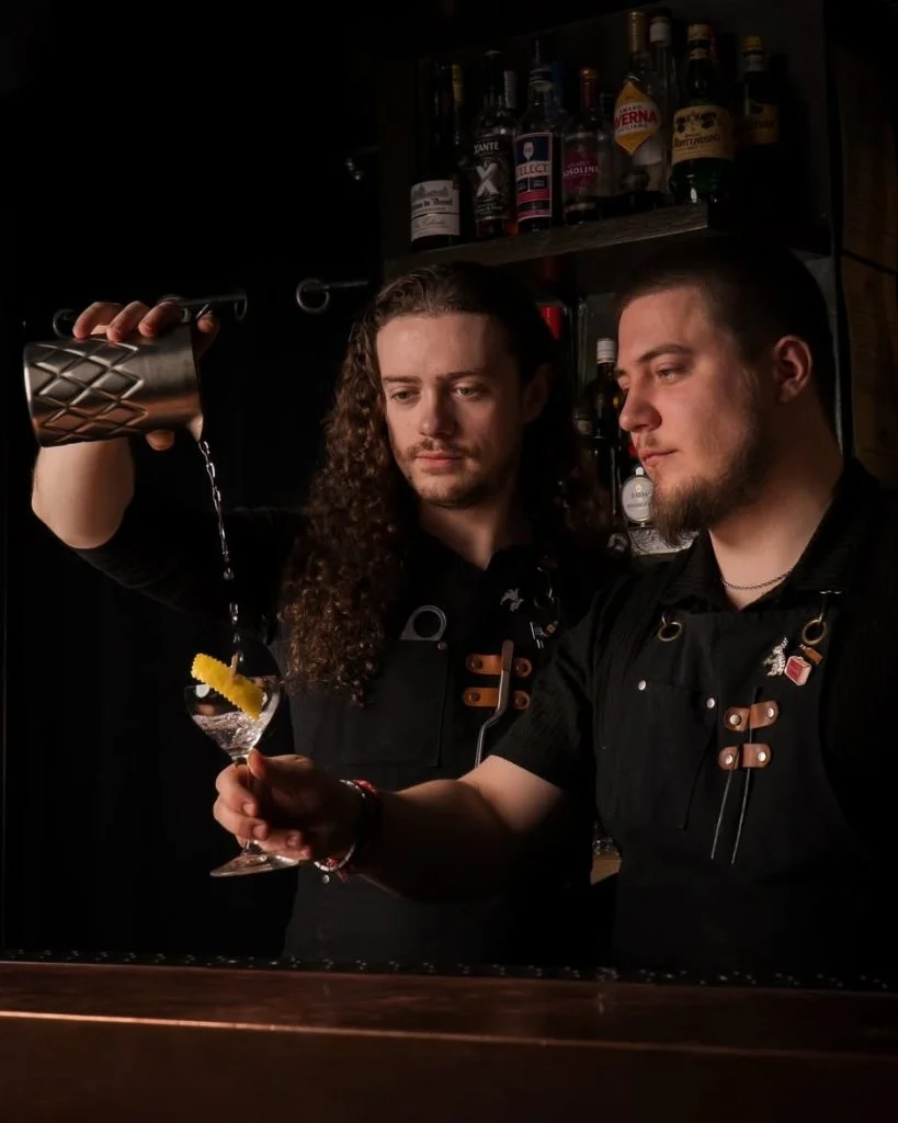 Two bartenders at The Plotting Parlour pouring a cocktail for Brighton Cocktail Festival.