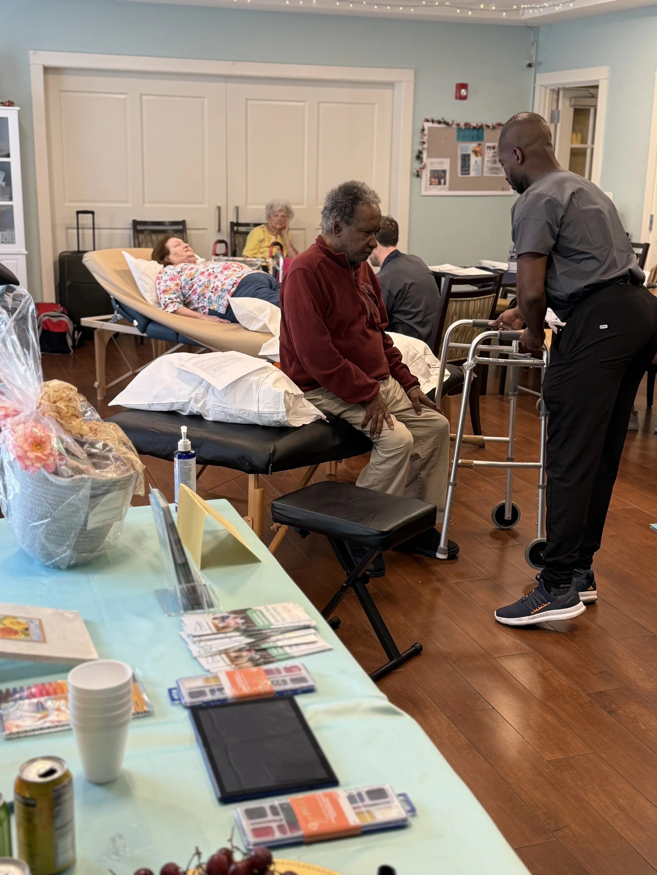 Older adults and caregivers participating in a community wellness event featuring therapeutic massage services from Senior Touch Massage Professionals.