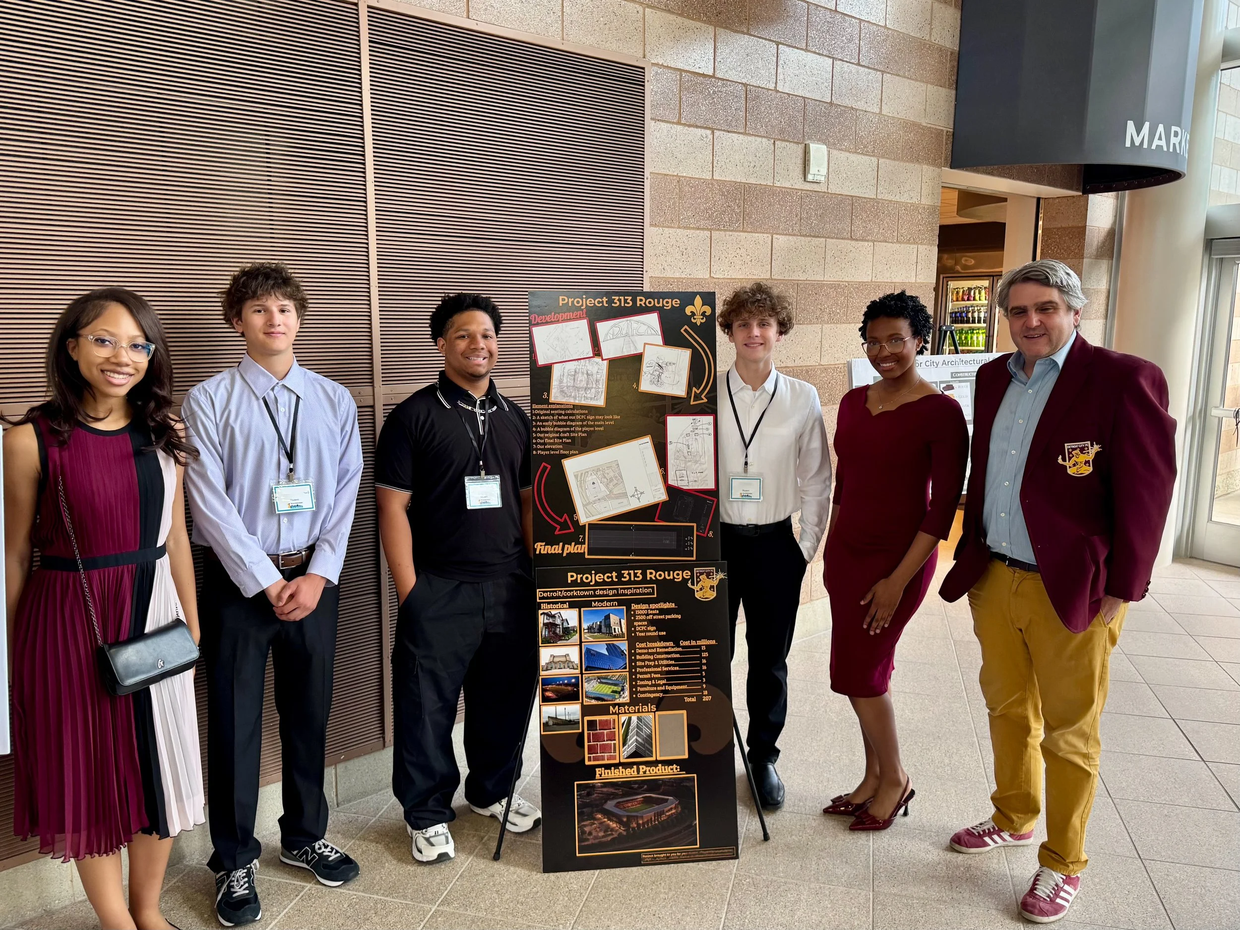 Sean Mann with team of students and their project display for the 2026 Detroit FC Project