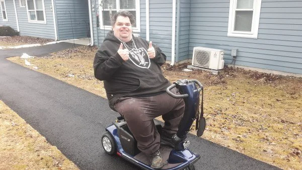 Chris on Electric Scooter.jpg