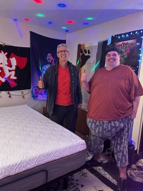 Chris Lucas and Chris De in front of bed.jpg