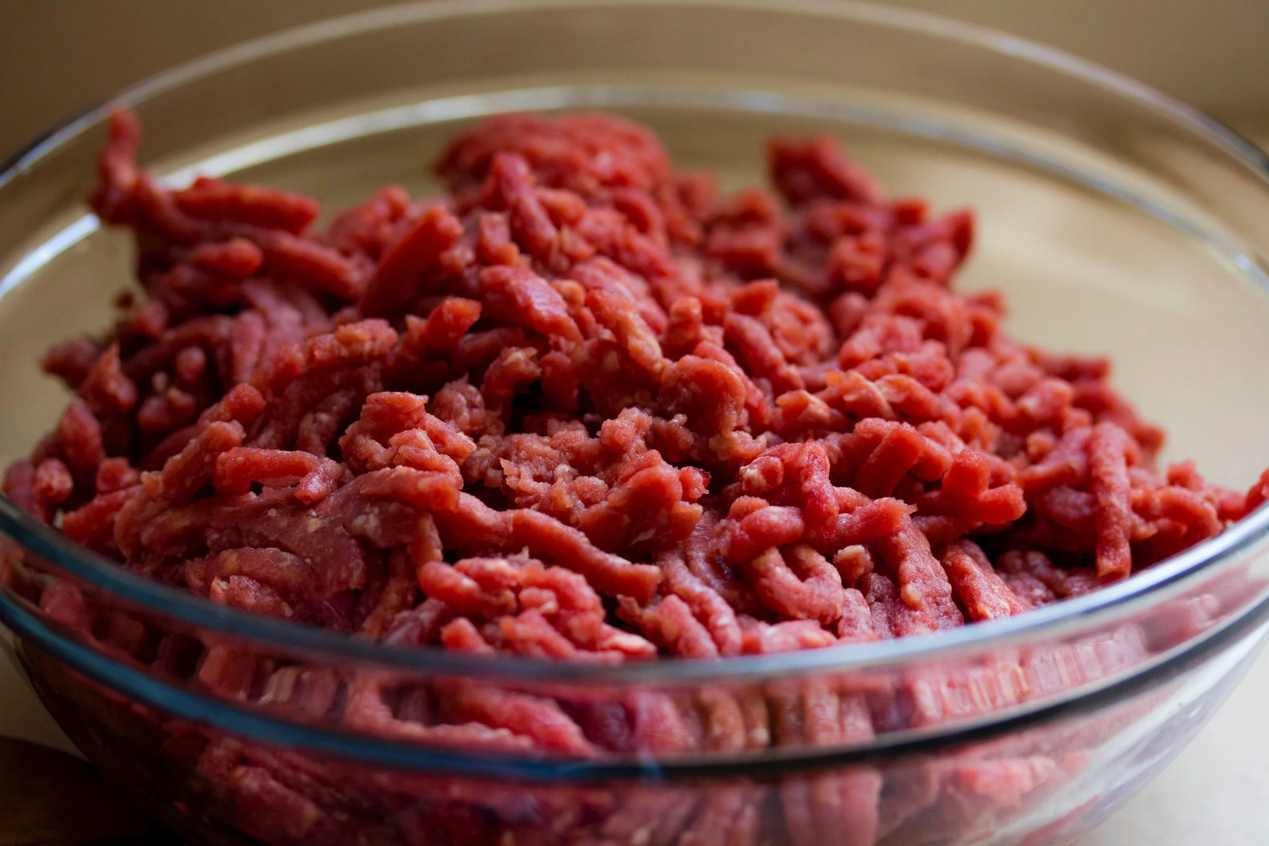 Freshly prepared 100% grass-fed ground beef in a simple bowl.