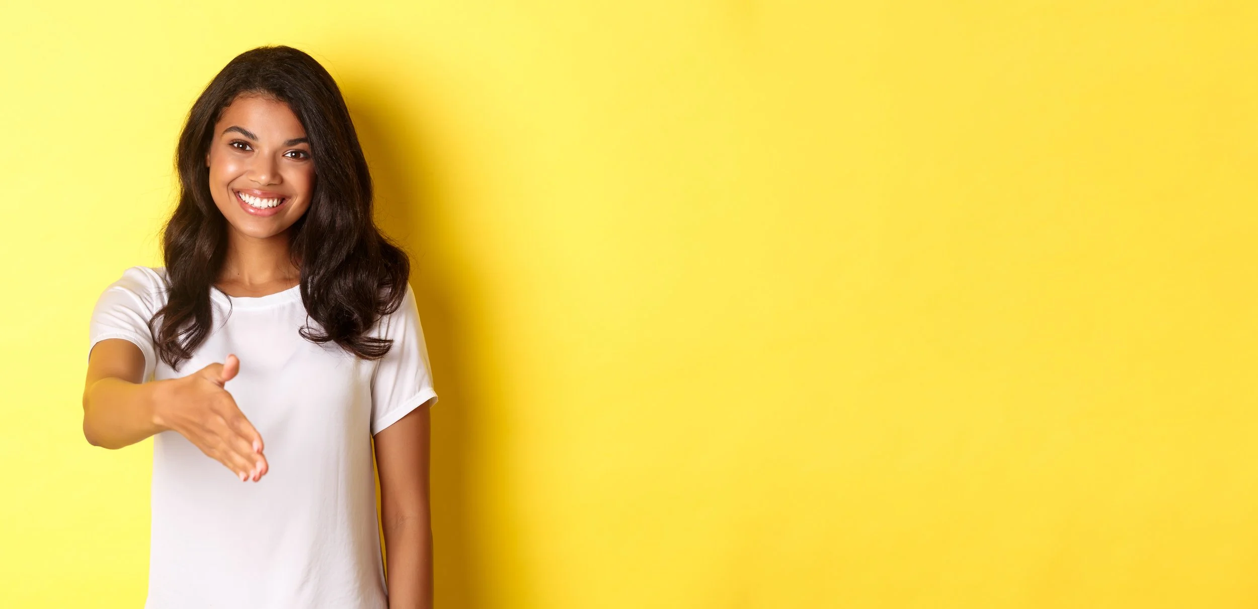 Graphic showing a woman extending a handshake on a yellow background with text reading “The Welcome Email” and explaining that when someone joins your list, they’re paying attention and that moment matters for small businesses.