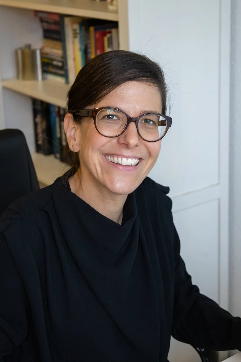 Yvonne sitting at her desk, smiling