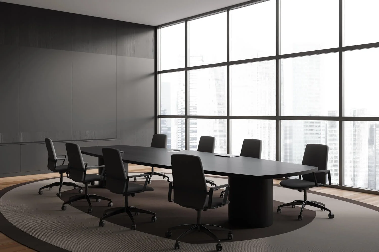 Modern conference room with a black table and chairs, overlooking a city skyline through large windows