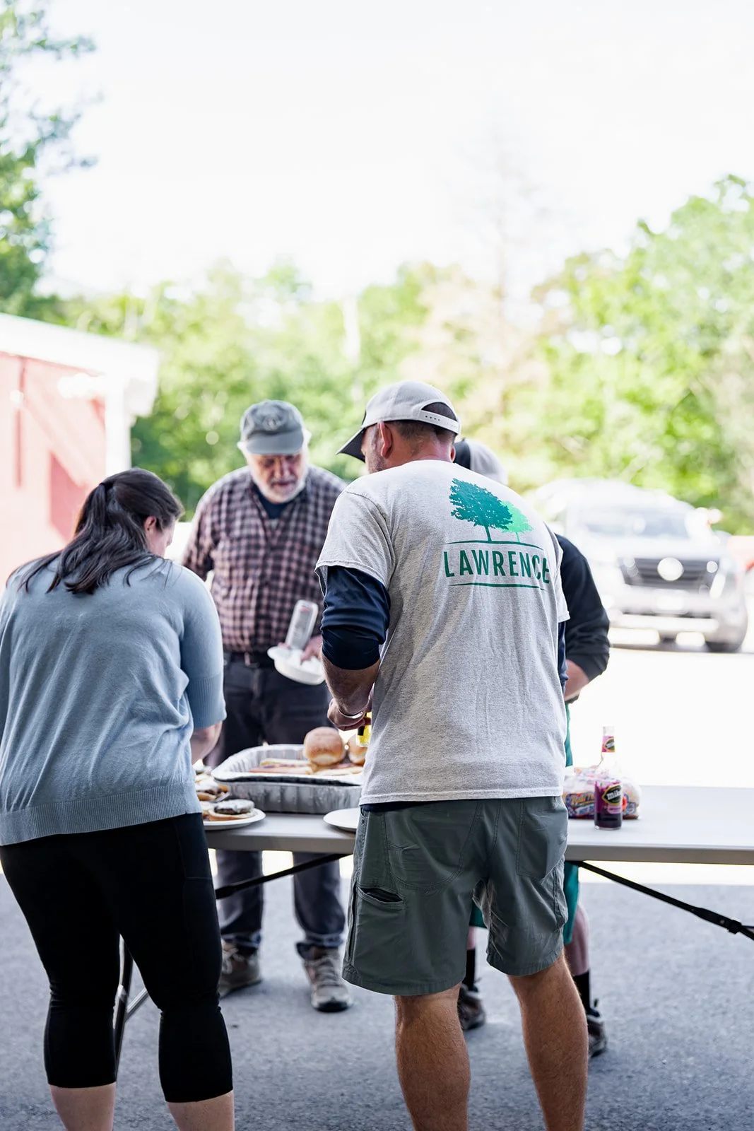 Staff bonding at outdoor company picnic hosted by Lawrence Property Management