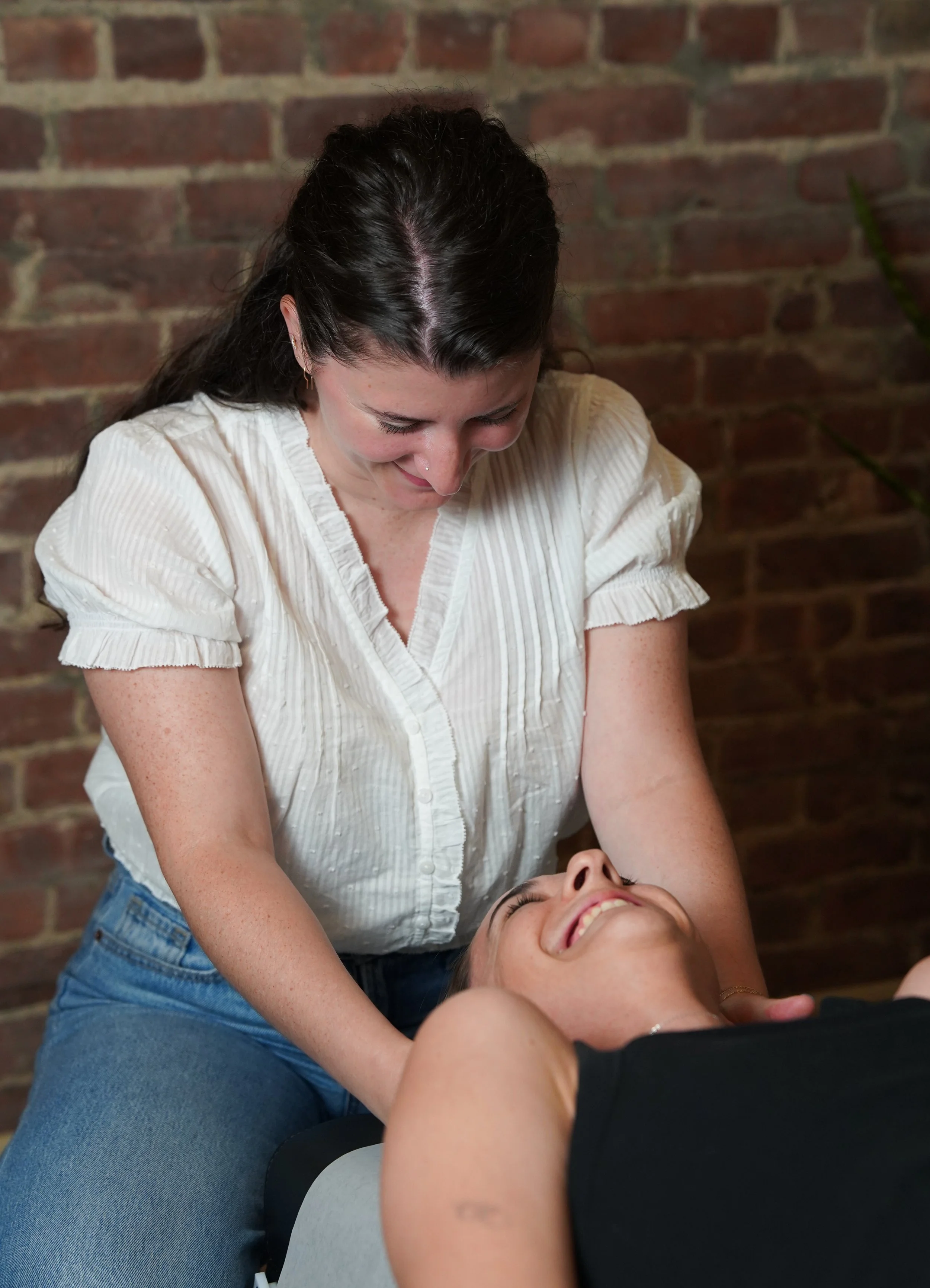 Female Chiropractor laughing with female patient