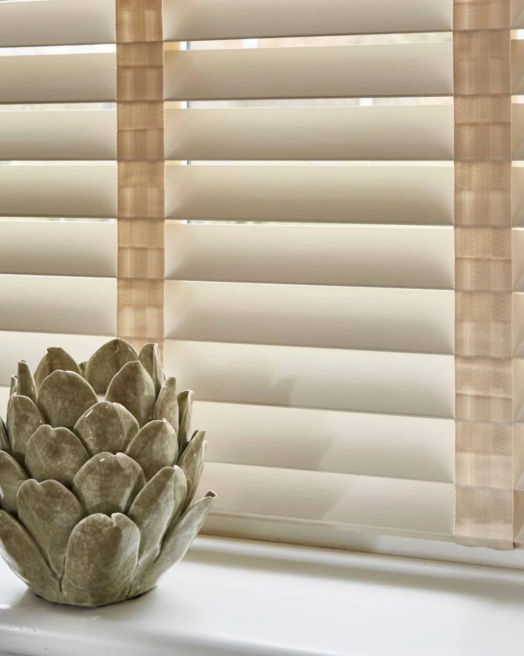 Custom made to measure venetian blinds in basswood oxford with a botanical ornament