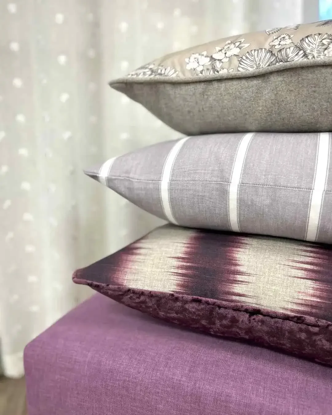 Stack of three handmade cushions in iliv and warner house