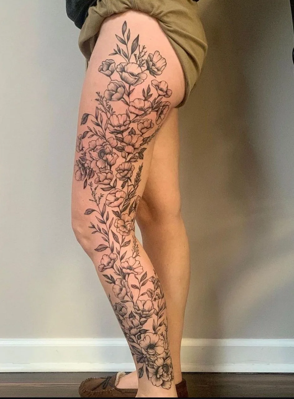 With elegance and grace Bethany fabricated these blackwork wildflower tattoos. They inch their way up this lovely lady's leg, meandering with delicately ease over muscular curves and bows from her ankle all the way up to her hip.