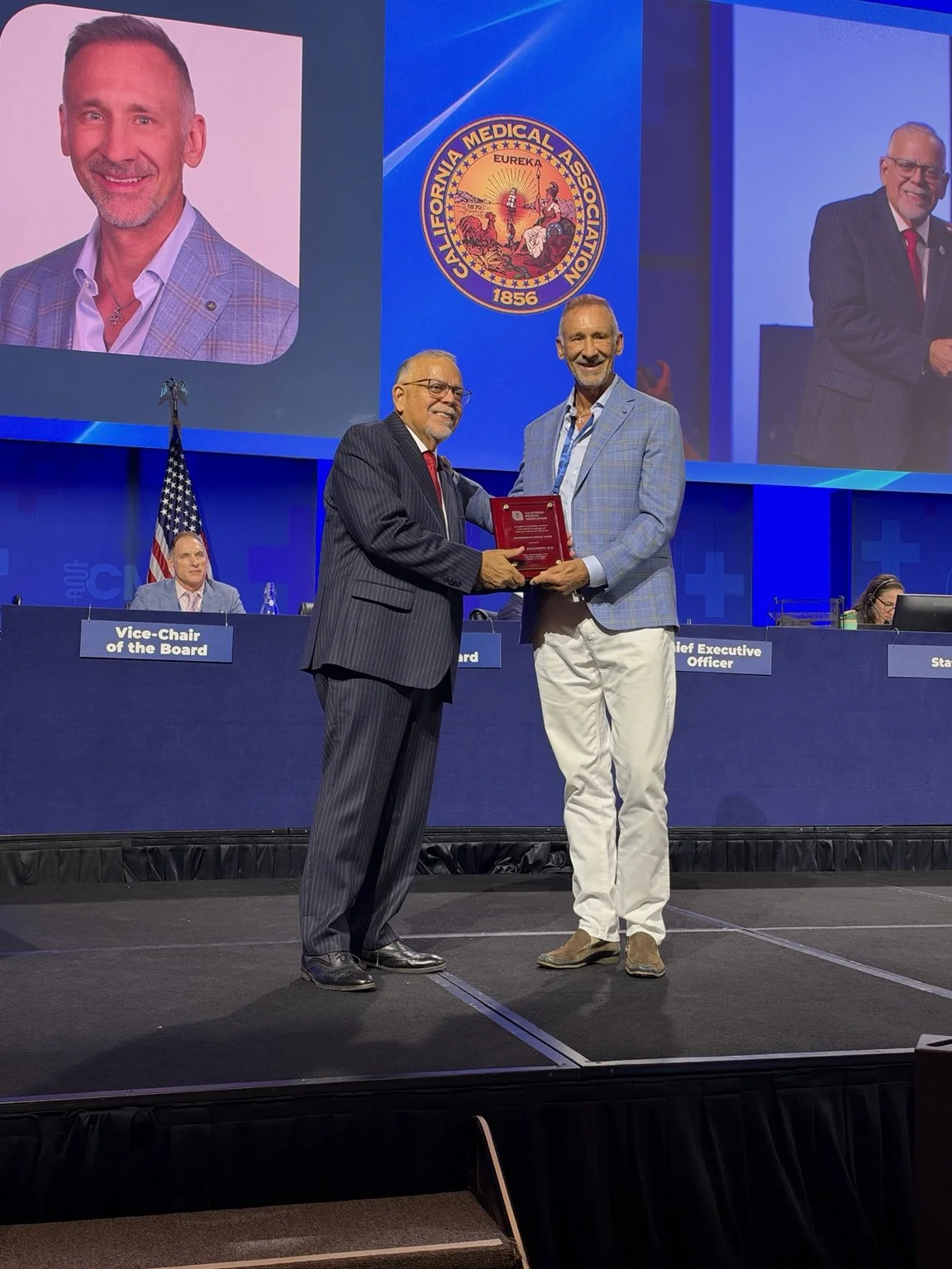 Dr. Paul Dougherty receiving the 2026 CMA Compassionate Service Award onstage in Sacramento.
