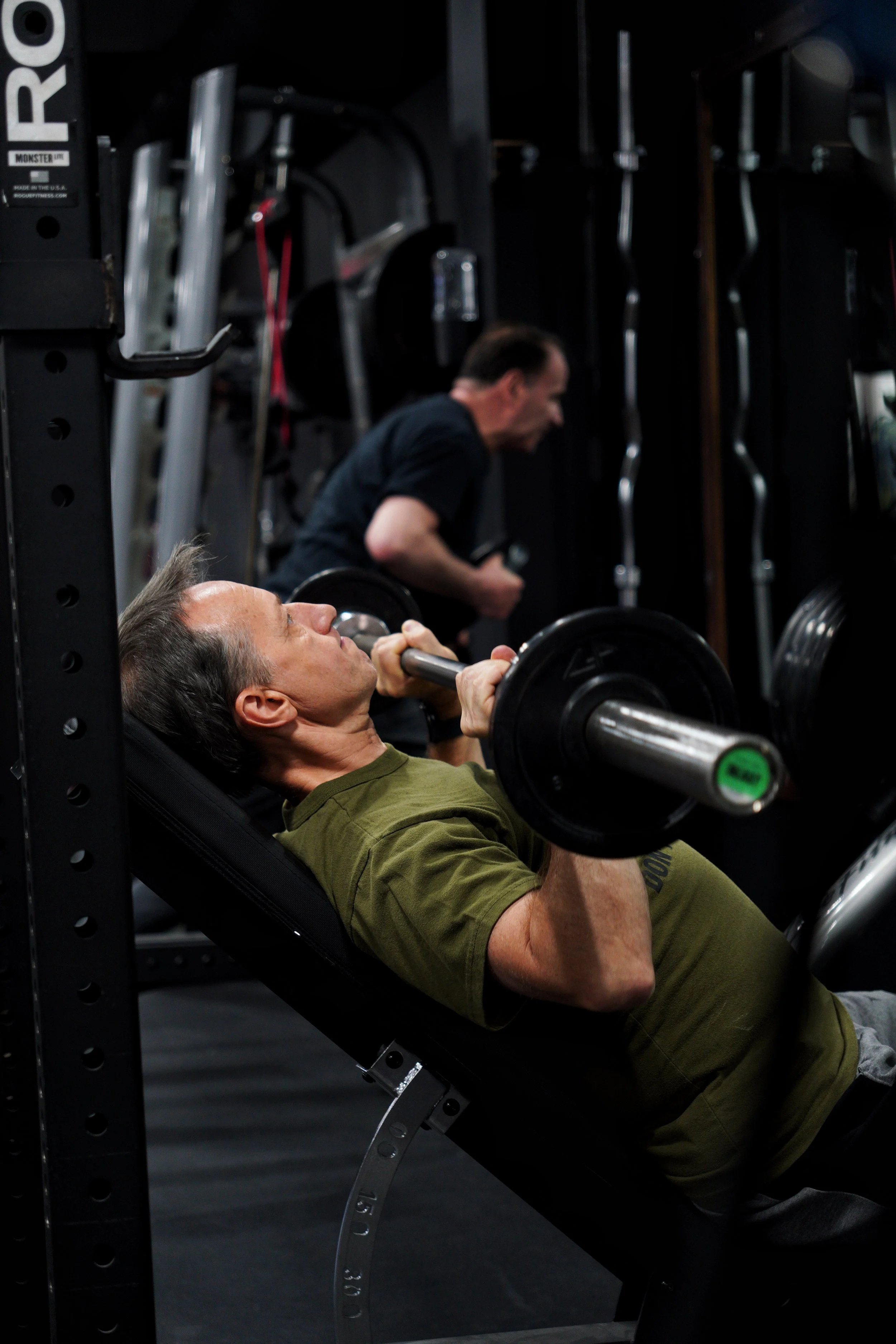 A member at EMBODI Fitness bench pressing.