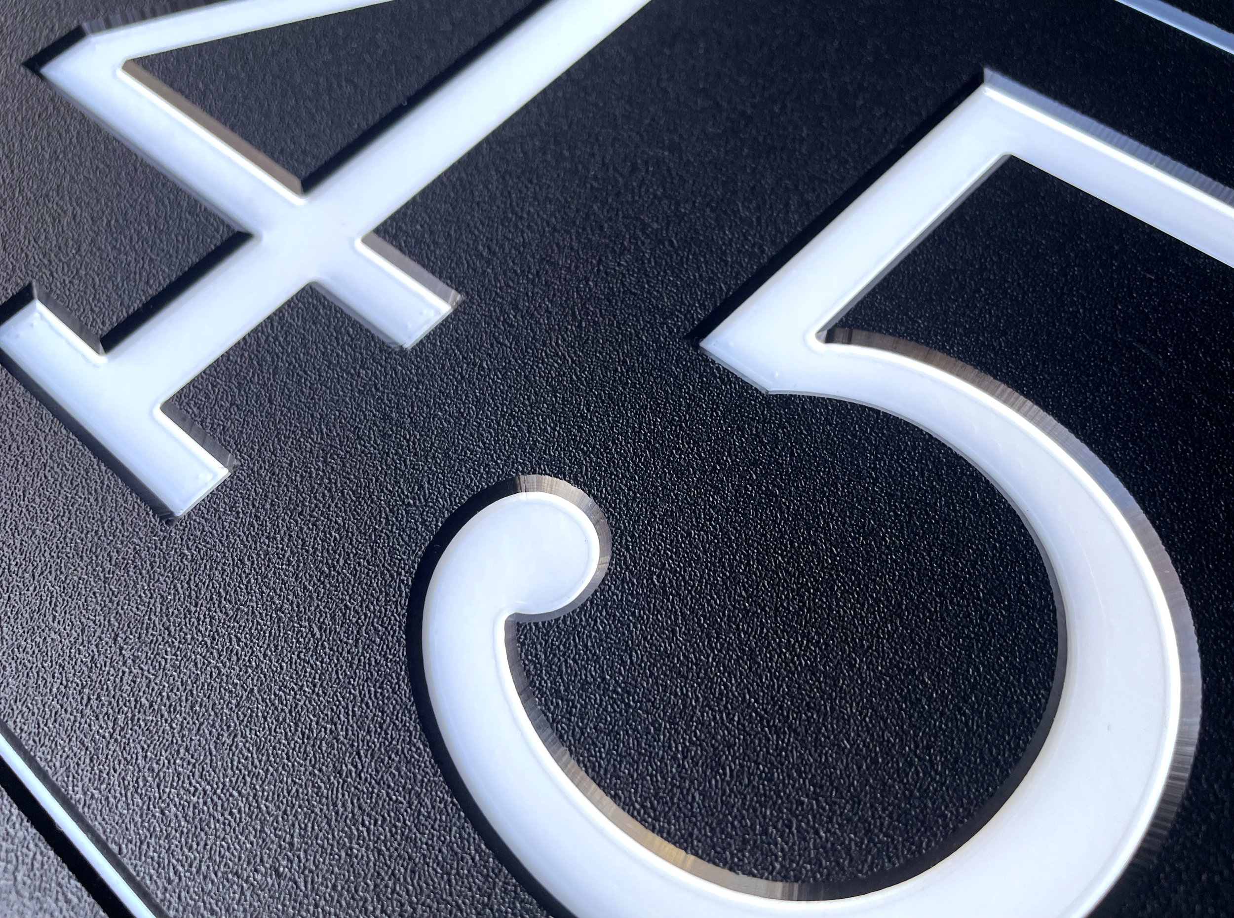 detail-of-house-number-sign-black-address-sign-white-numbers.jpg