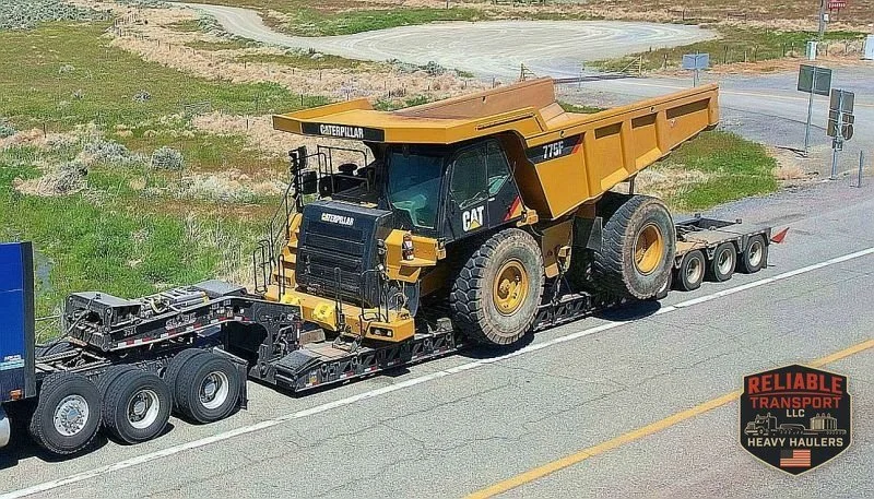 The loaded haul truck rolling along a two lane highway on a multi axle trailer