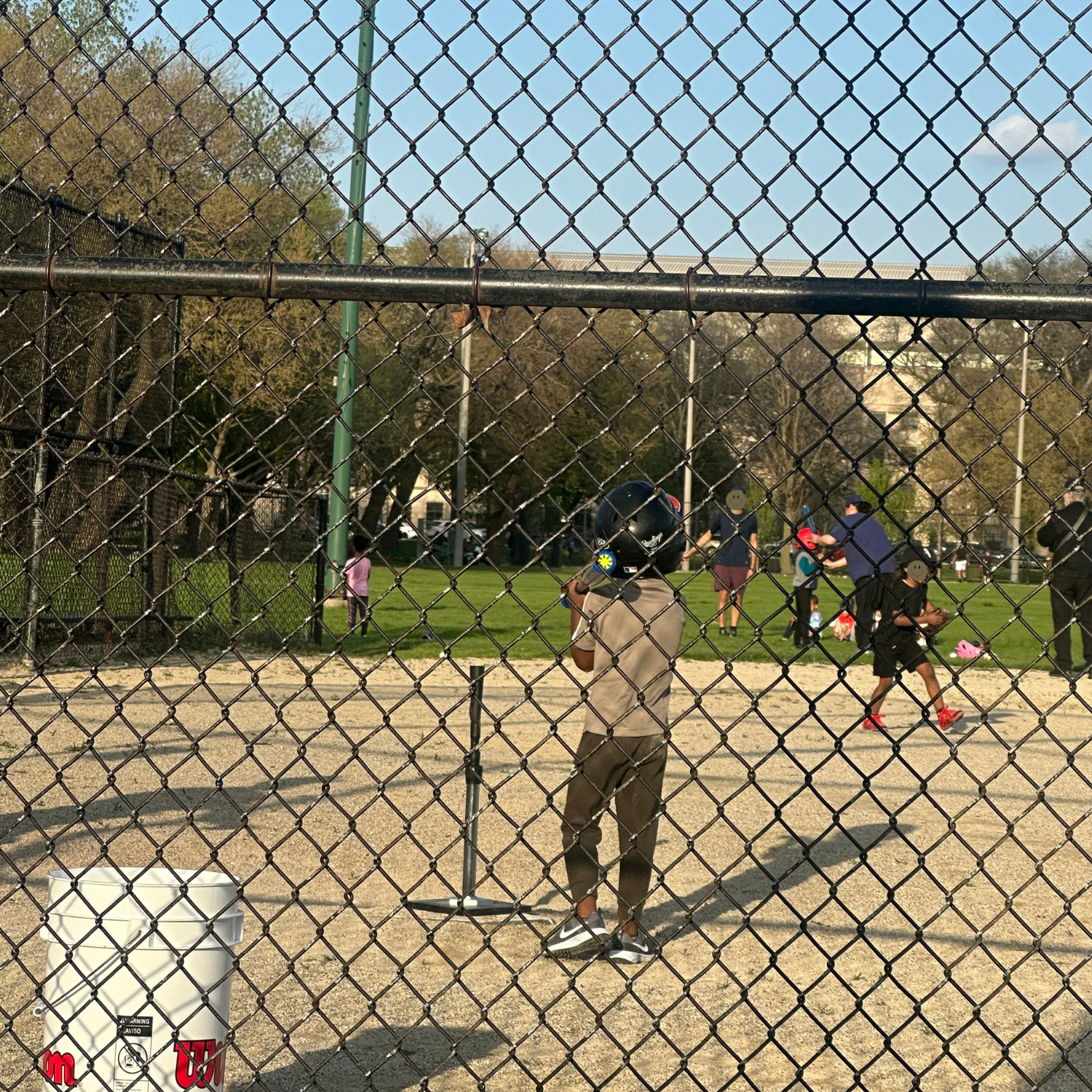 child standing holding tball bat