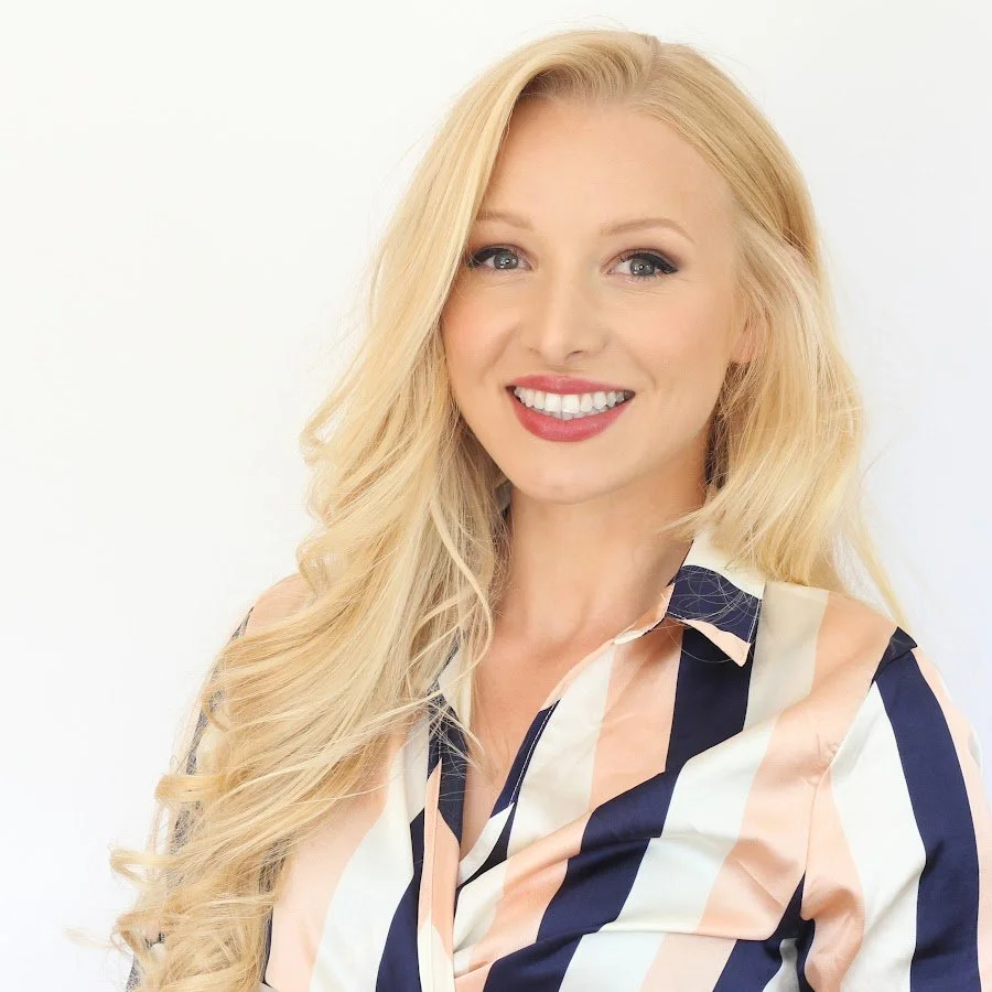 Smiling woman with long blonde hair wearing a striped shirt