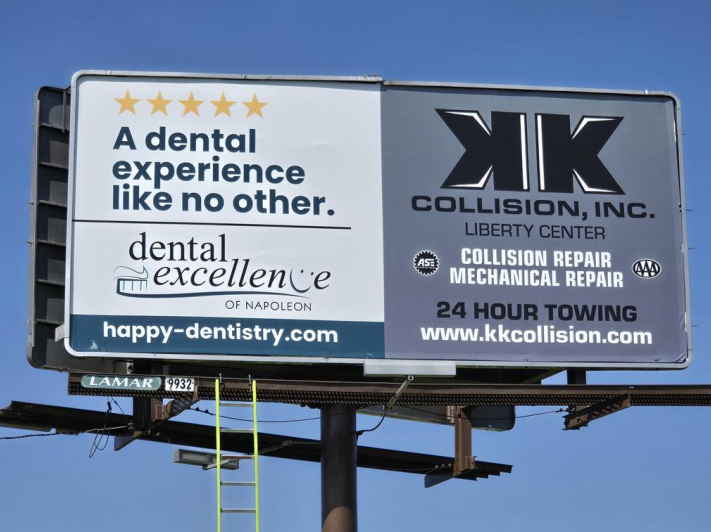 Billboard advertising a dental clinic and an auto collision repair shop, featuring services like collision repair, mechanical repair, and 24-hour towing.