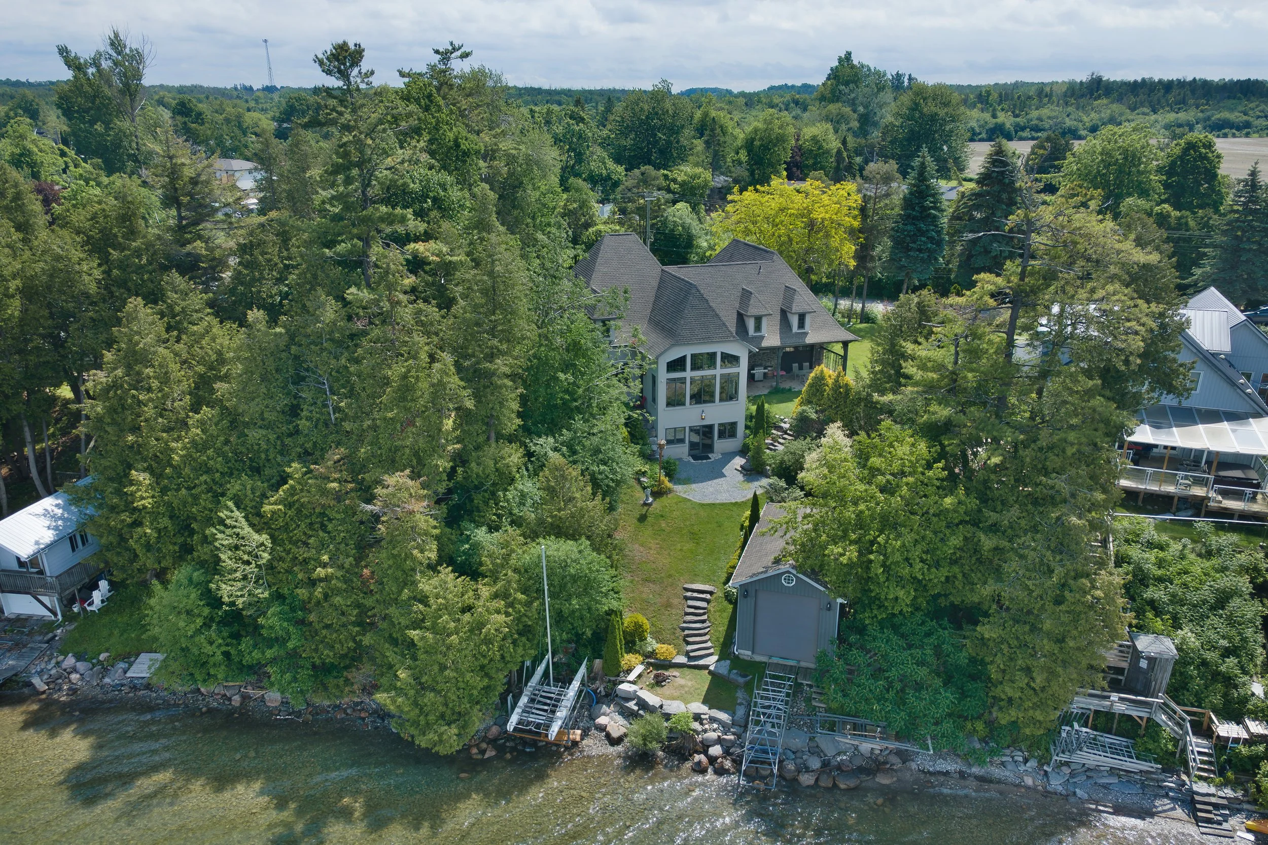 Overhead drone view of a luxury lakefront property in Beaverton - Real Estate Photography