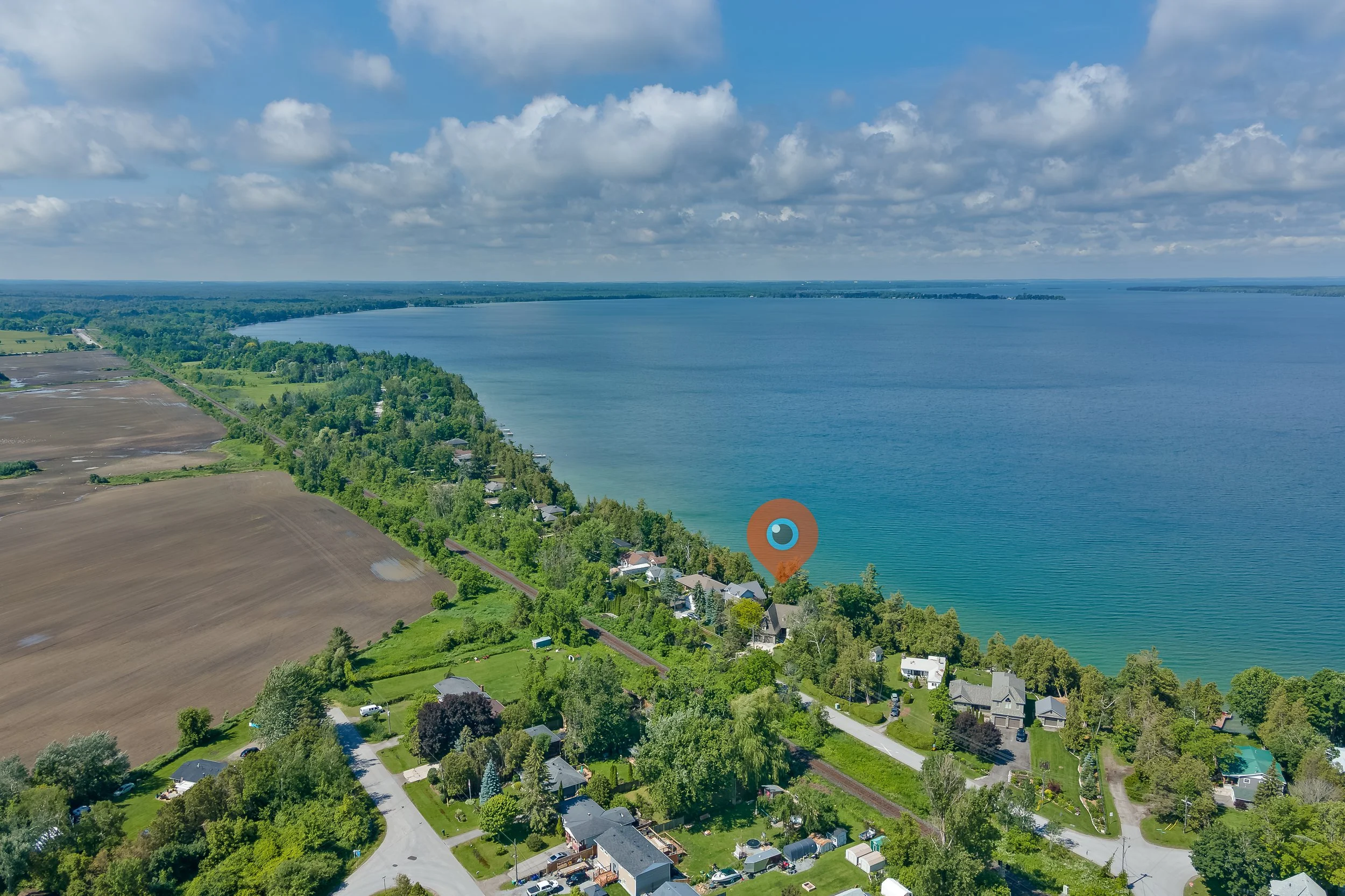 Overhead drone view of a luxury lakefront property showing the lake in Beaverton - Real Estate Drone Photography
