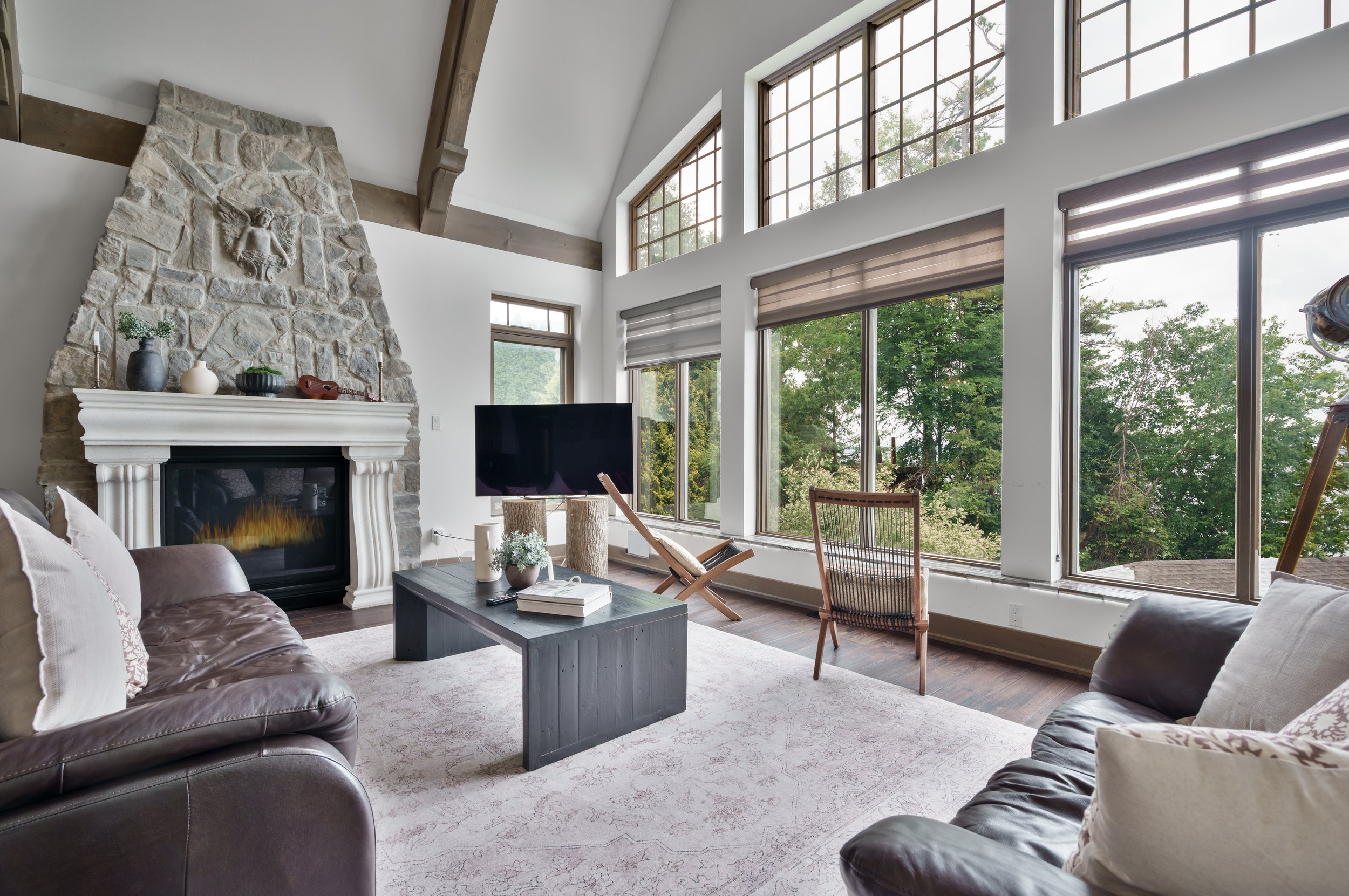 Living room with fireplace and large window view in Brock - Real Estate Photography