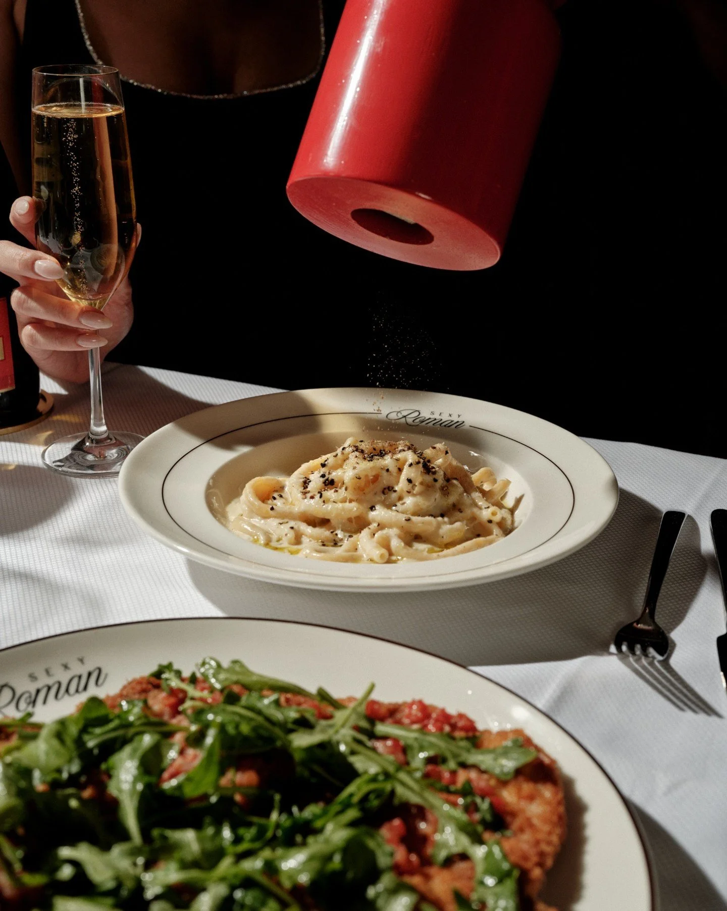 Say when. The final touch &mdash; parmesan, pepper, and a little Roman flair. 🍝