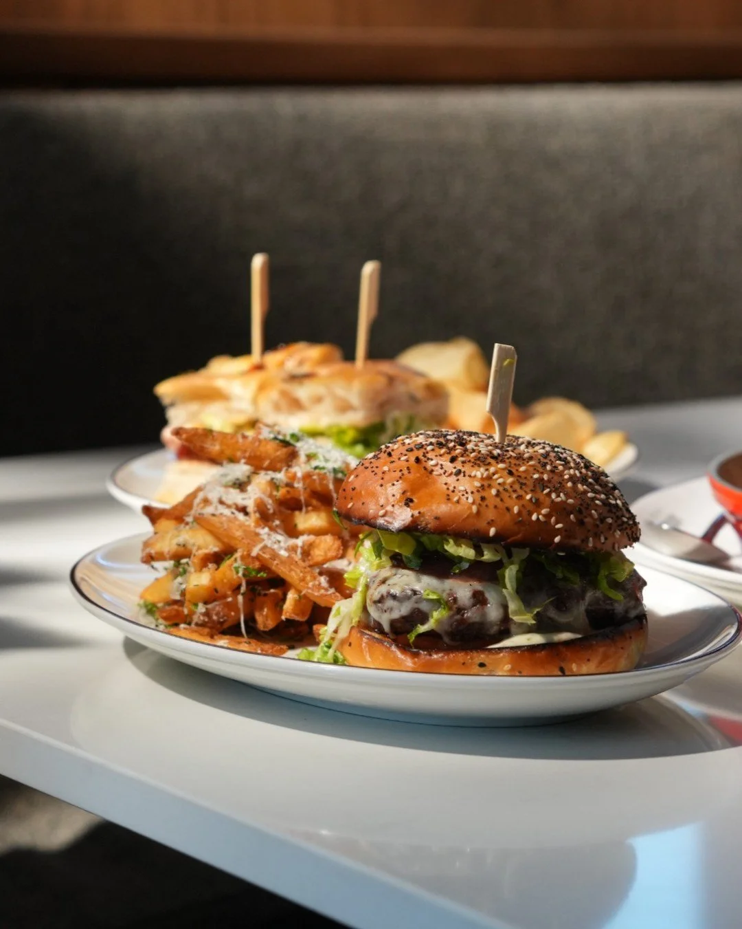 POV: A Three Martini Lunch awaits you. Our Roman Burger is stacked, sauced, and ready for its close-up. Pairs well with the perfect martini, served just the way you like it. 🍔
