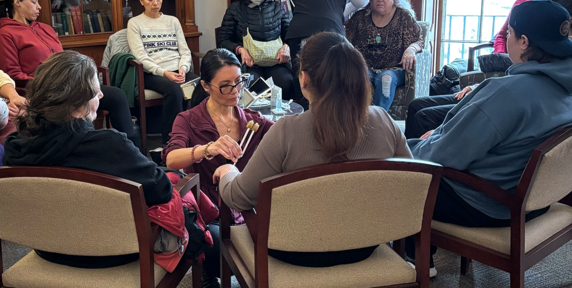 Practitioner giving acupressure treatment at a healing pop up