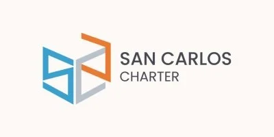 Logo for San Carlos Charter featuring a geometric design with blue and gray elements and orange accents.