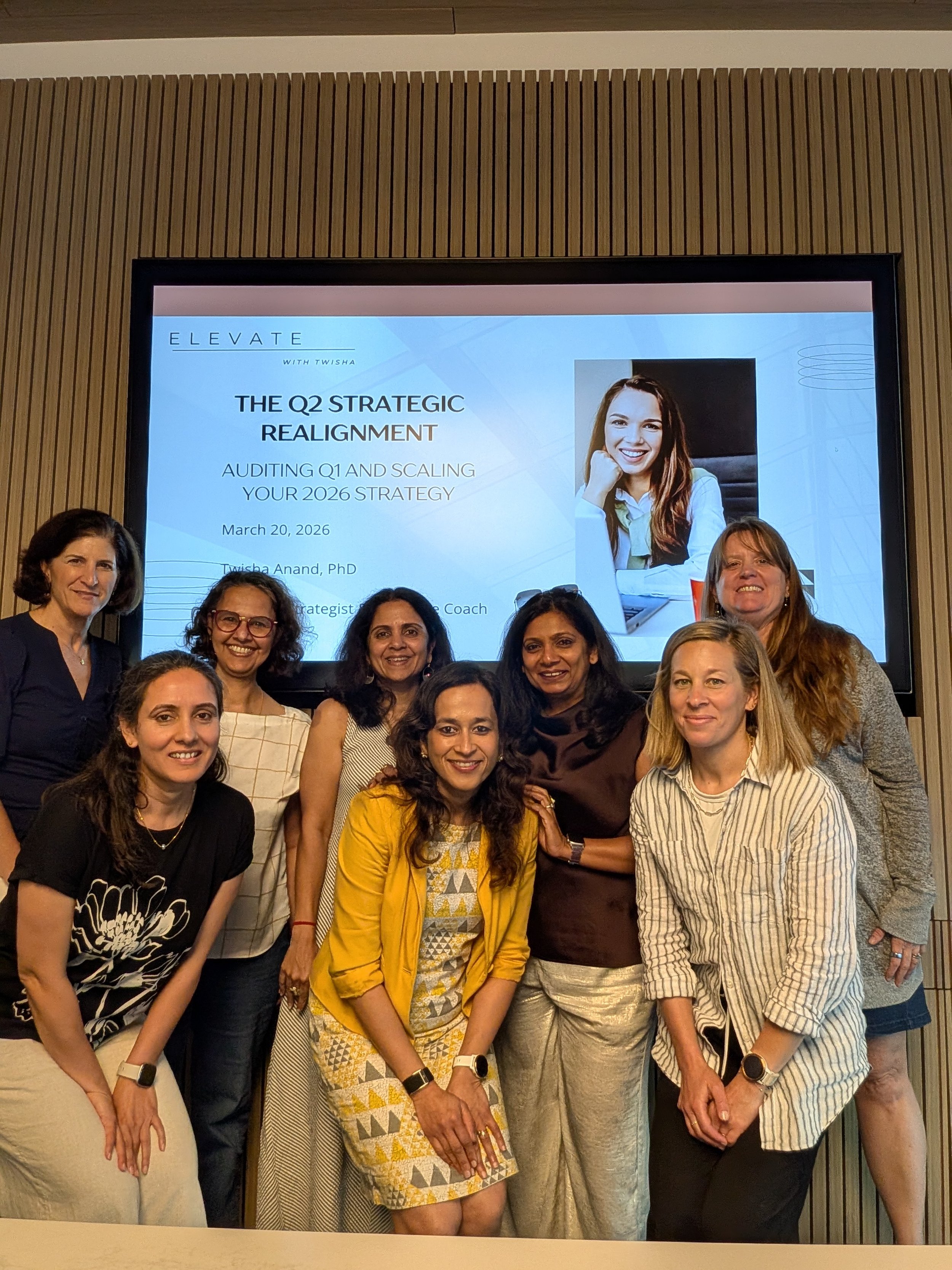 A diverse group of professional women posing together during the "Q2 Strategic Realignment" workshop hosted by Twisha Anand, PhD, in San Carlos, CA.