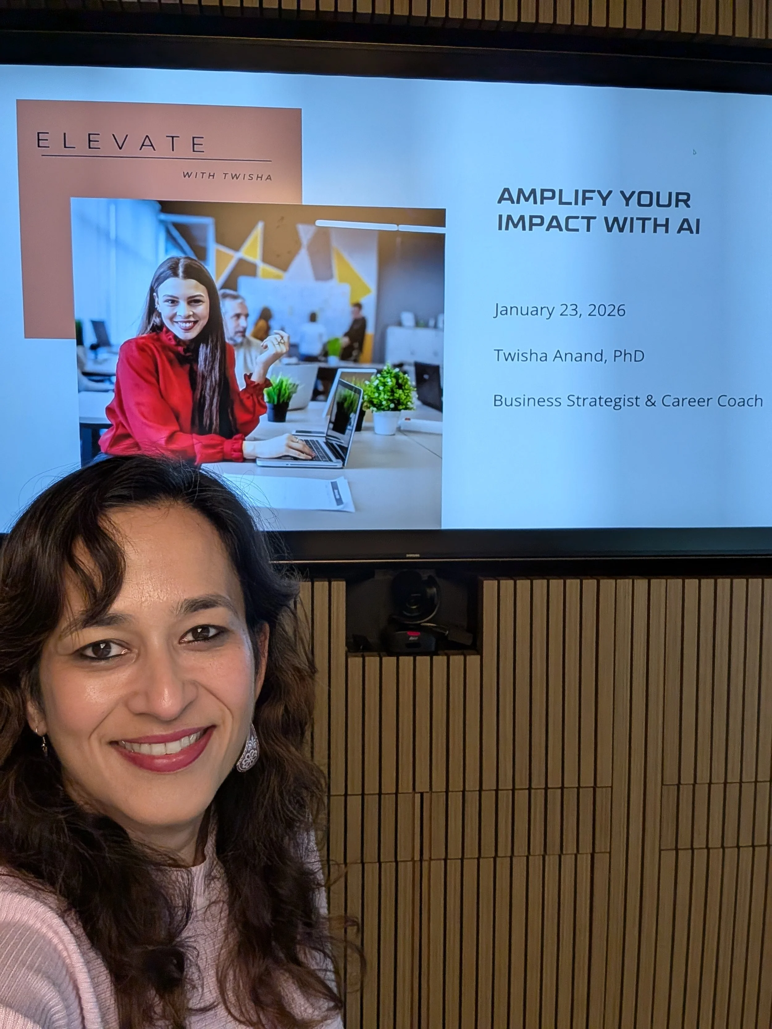 Twisha smiling in front of a screen