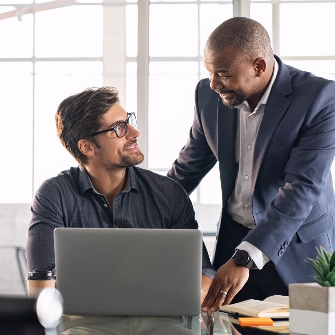A diverse group of professionals collaborating around a conference table, illustrating strategic leadership and high-context team management.