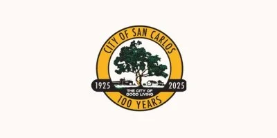 Logo celebrating 100 years of the City of San Carlos from 1925 to 2025, featuring a large tree, houses, and the phrase 'The City of Good Living'.