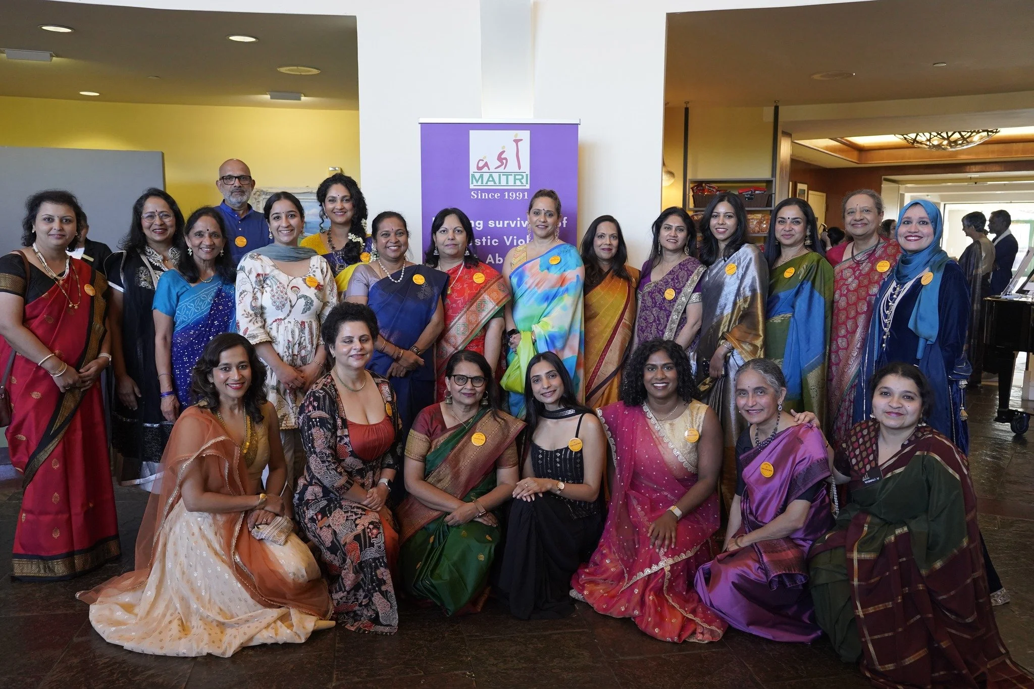 Twisha Anand collaborating with mission-driven volunteers and executives at the Maitri Gala, demonstrating functional fluidity and cross-functional leadership in a high-impact environment.