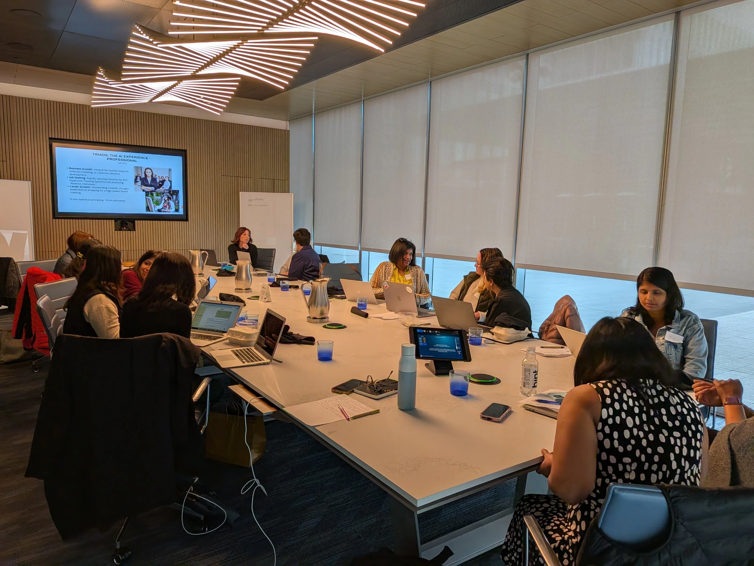 Group of professional women brainstorming around a meeting table
