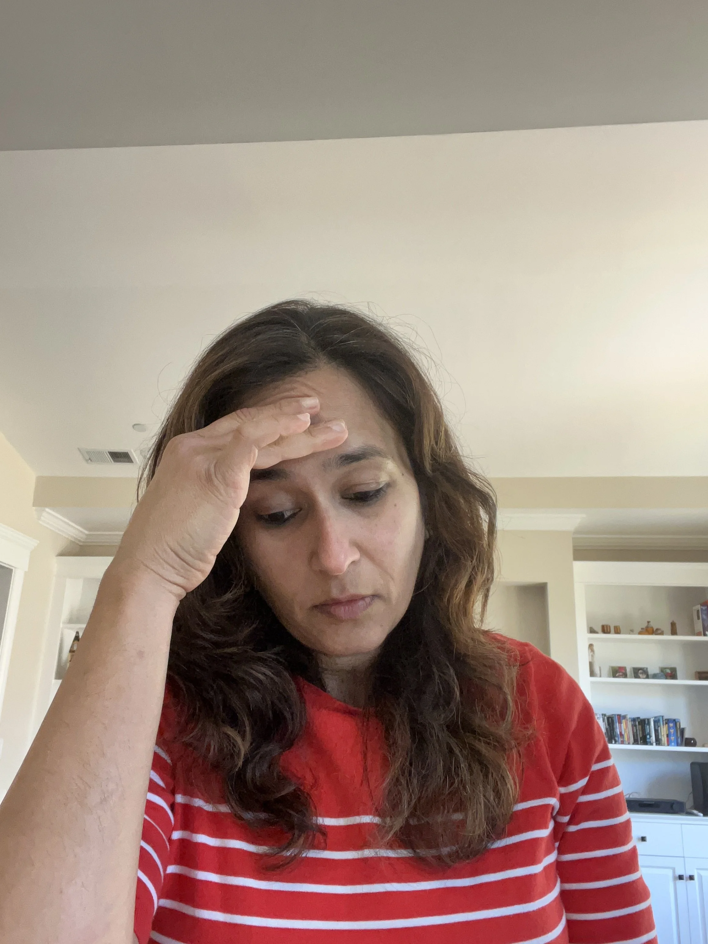 Remote worker at a laptop experiencing professional isolation and stress, illustrating the ‘Remote Paradox’ and the challenge of becoming professionally invisible in the 2026 market.