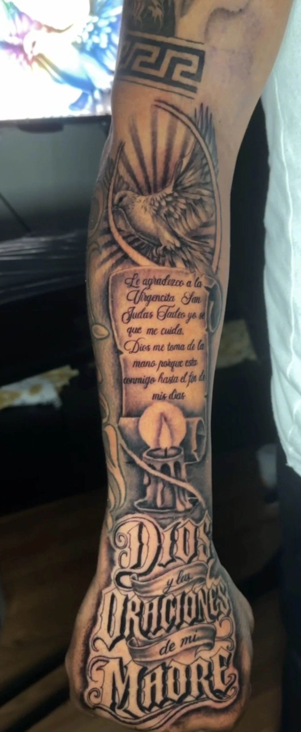 script tattoo on hand and outer forearm by Oscar. 