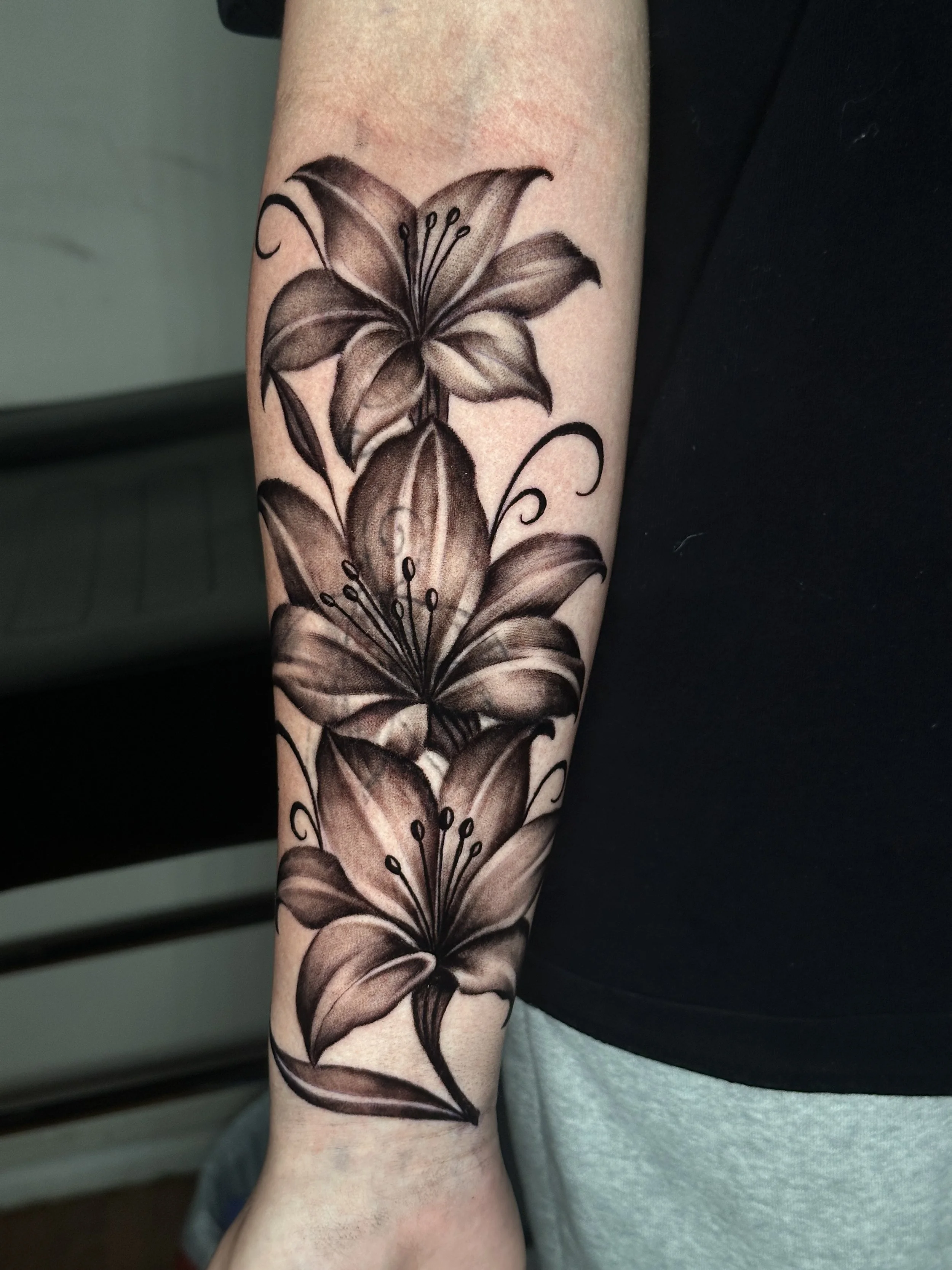Black and grey realism flower tattoo done by Oscar